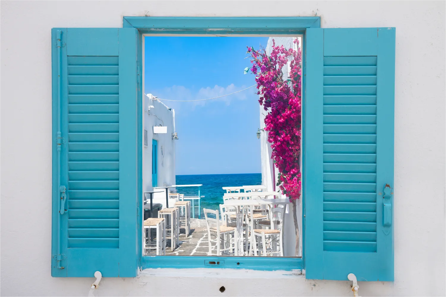 Beautiful view of a narrow street ending in the sea Through a Window in Paros