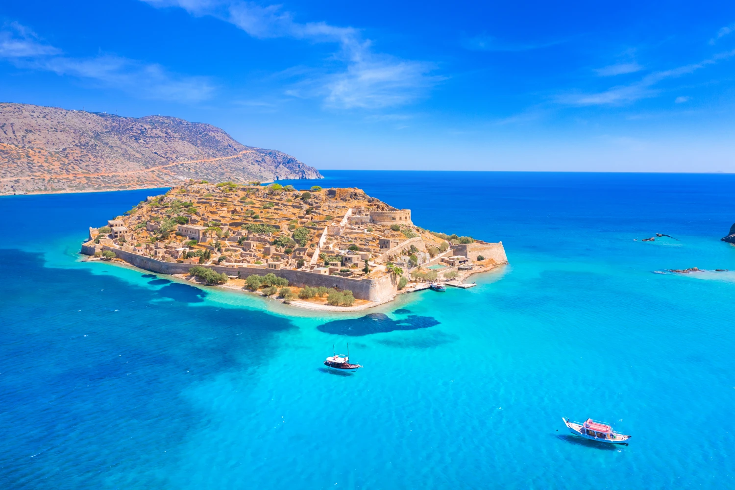 Take the ferry to Crete and if you have time, hop on the island o Spinalonga in Agios Nikolaos