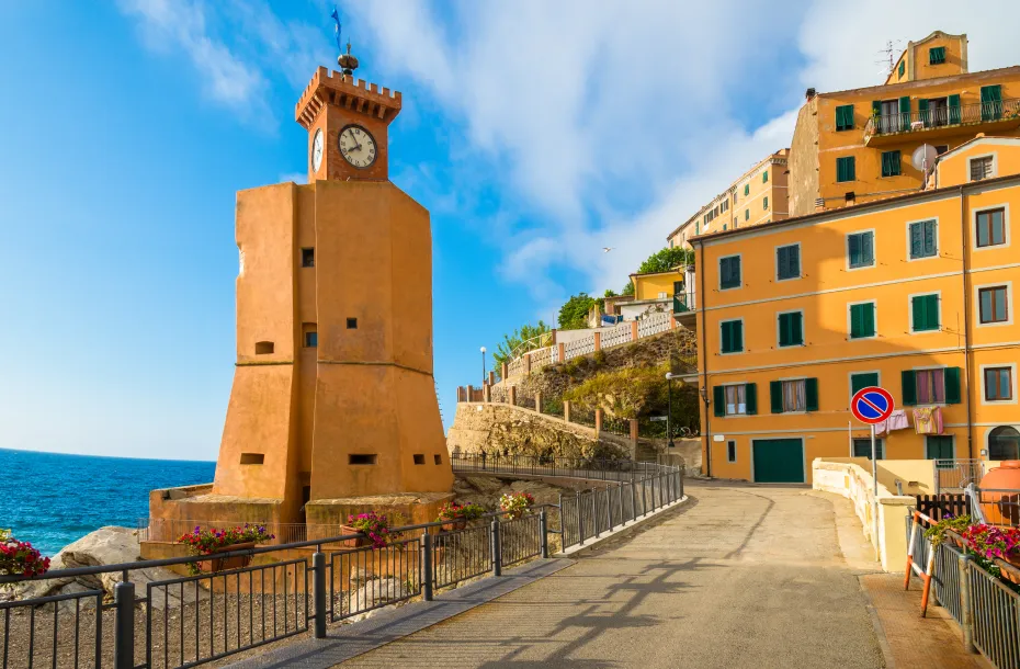 Beautiful promenade in Rio Marina, Elba Island, with clock lighthouse on the left