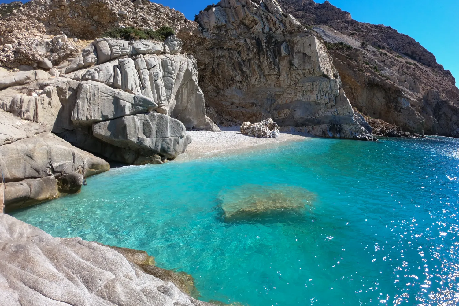 The rocky Bay Of Seychelles Beach In Ikaria with its crystal clear waters