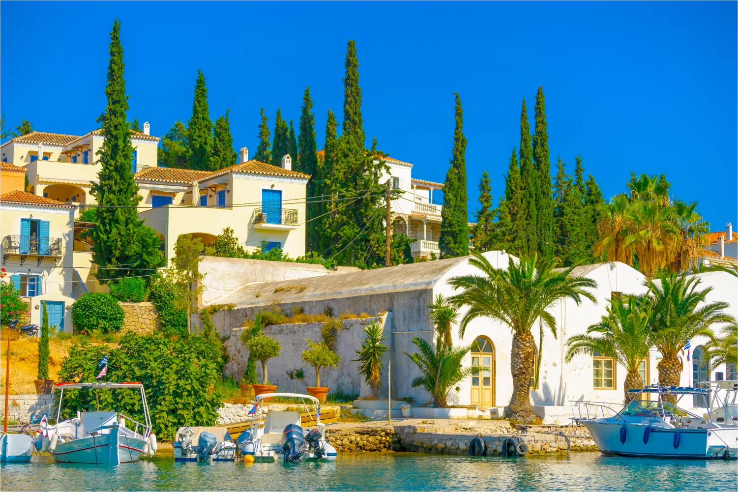 The Old Port Of Spetses with its tall trees and traditional houses