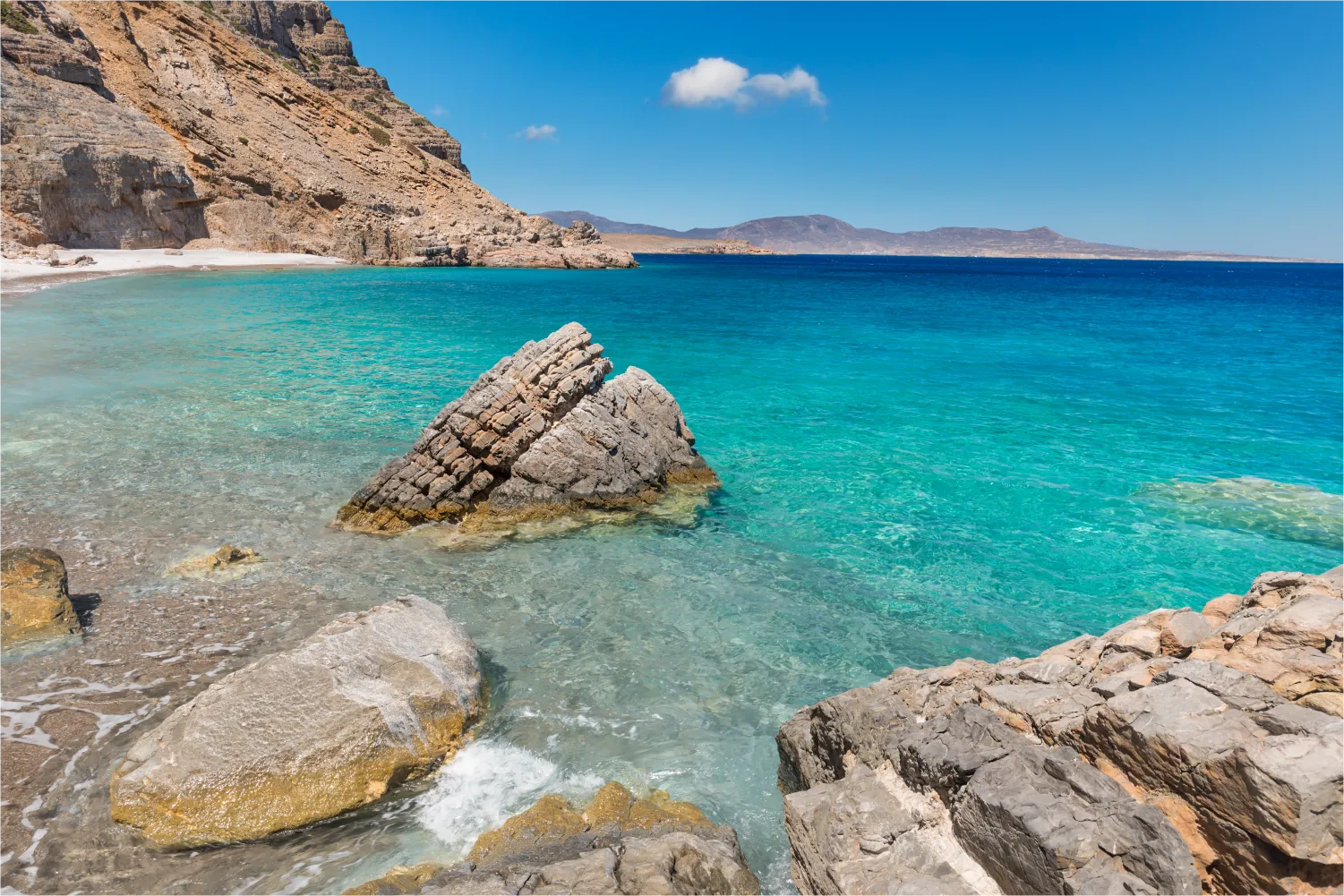 Beach At The Base Of The Rocky Walls Of The South Coast Of The Greek Island Of Kasos