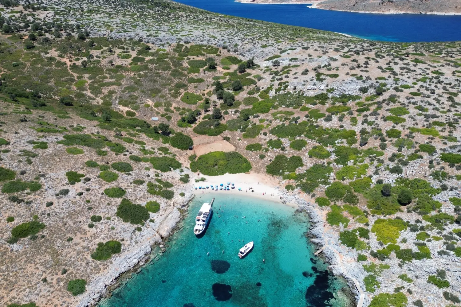 Aerial view of a small bay with two yachts in Skyros
