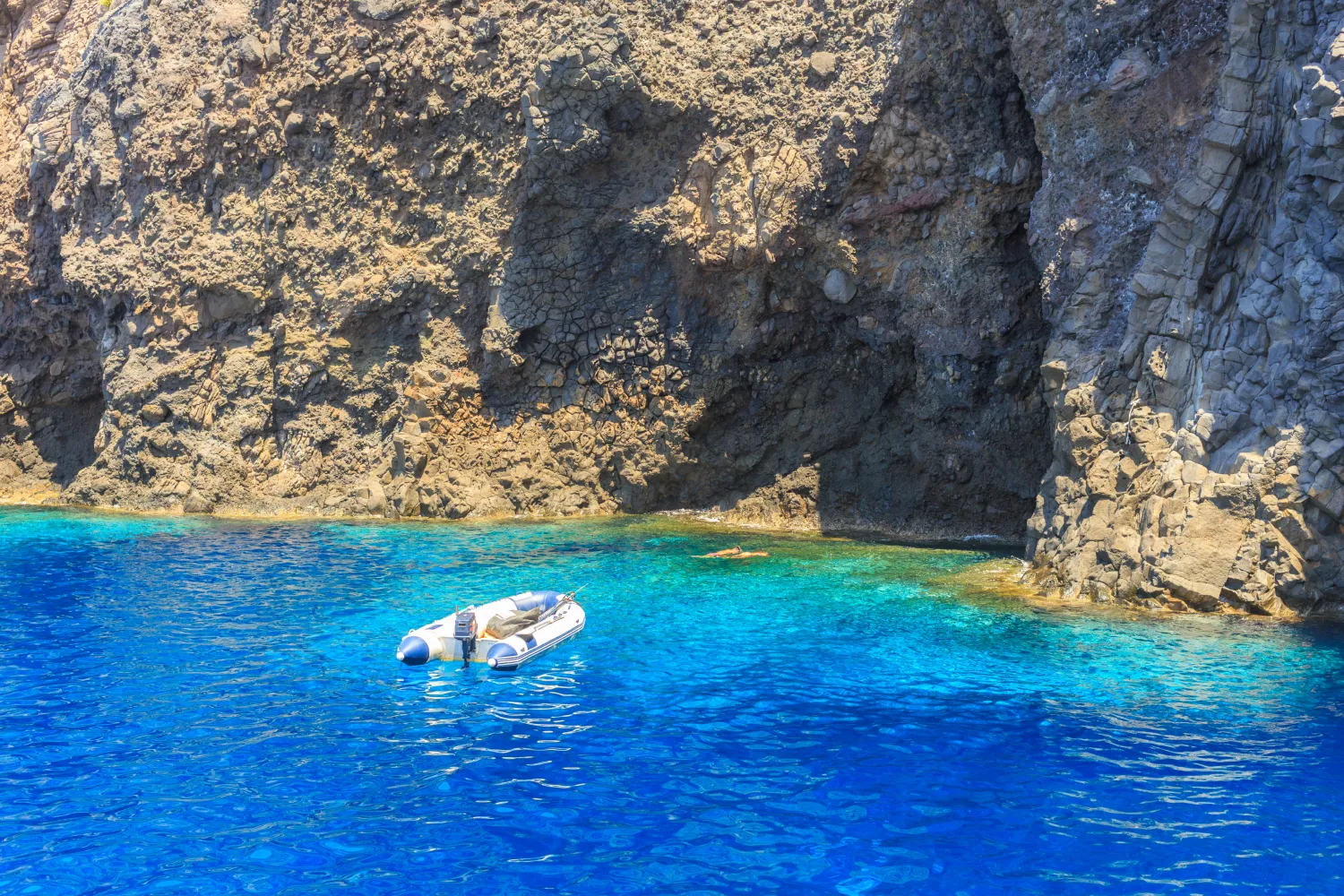 Transparent sea with iflatable boat in Filicudi