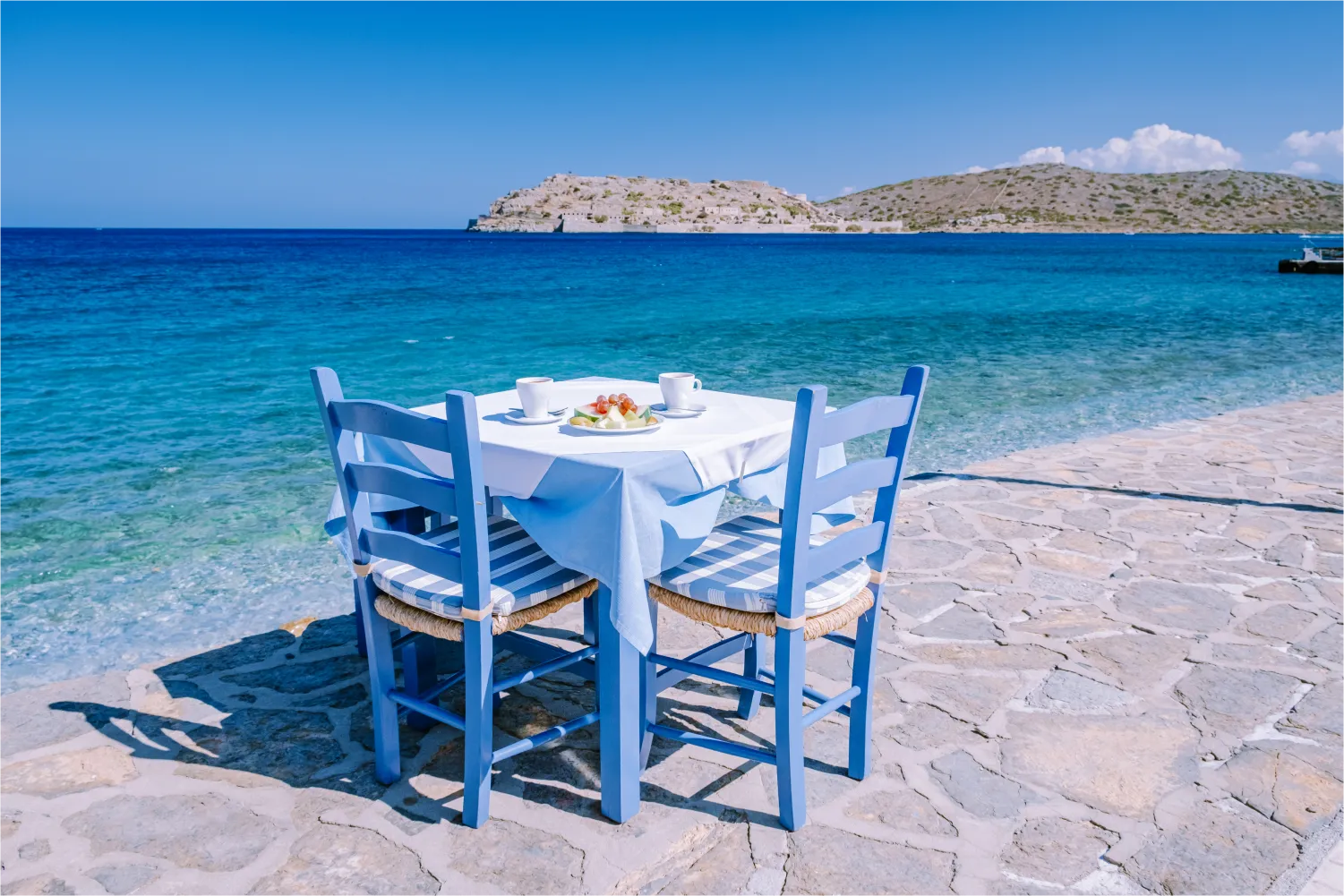 Traditional Blue Table And Chairs And The Beach In Lasithi