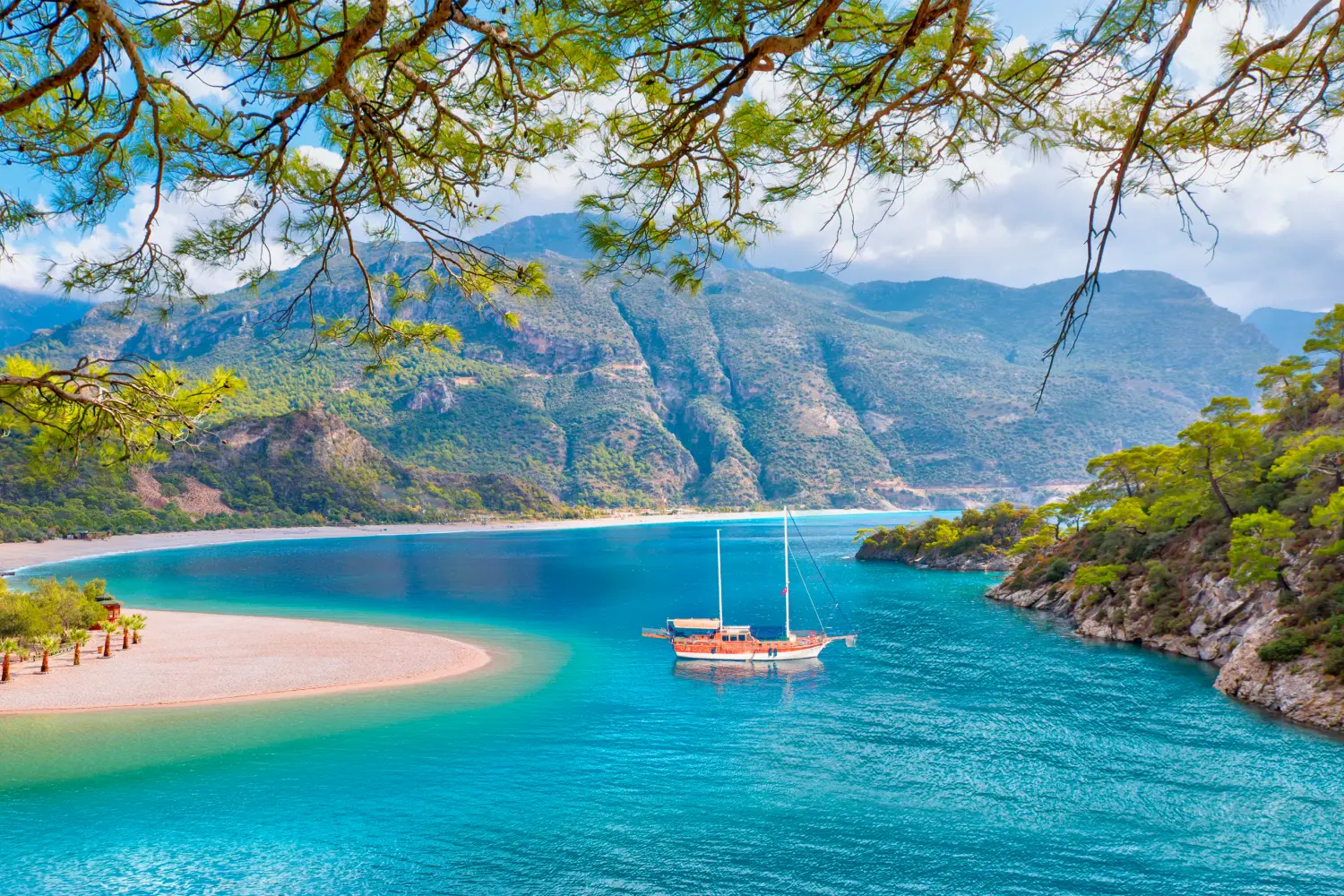 Overlooking at a touristic vintage ship sailing in a dramatic landscape in Fethiye