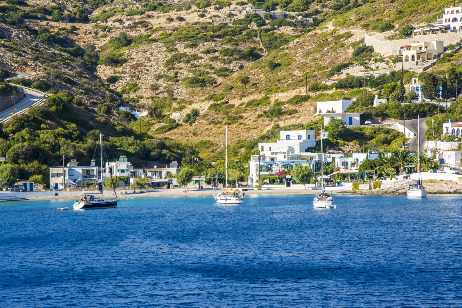 a small bay with boats and a mountainous background in Agathonisi
