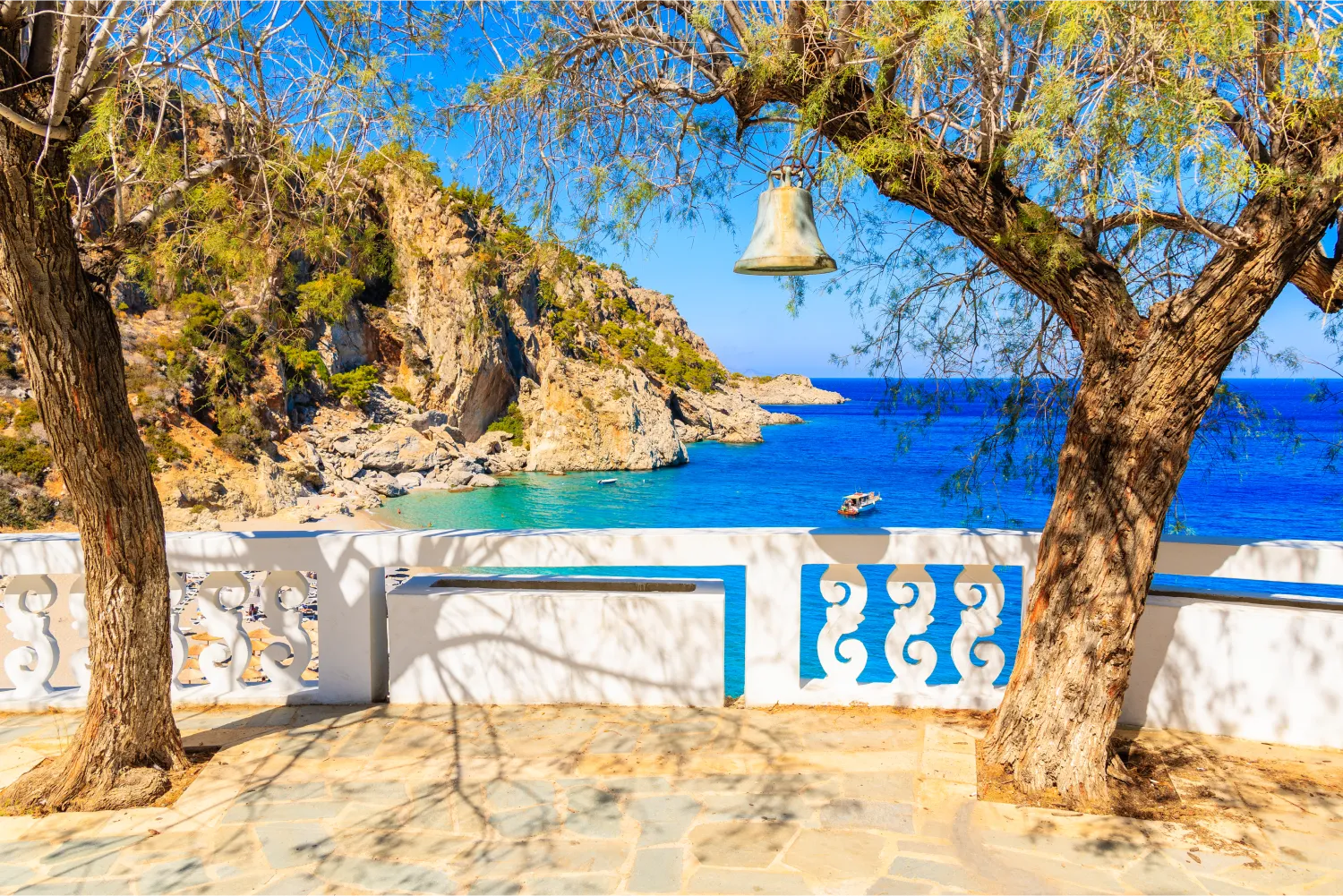 Bell Hanging On Tree And View Of Kyra Pynagia Beach From Church Terrace On Karpathos