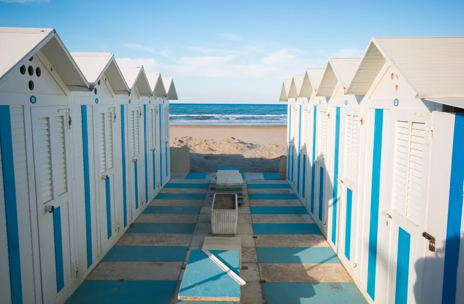 Blue-white beach huts in the beach of Pesaro