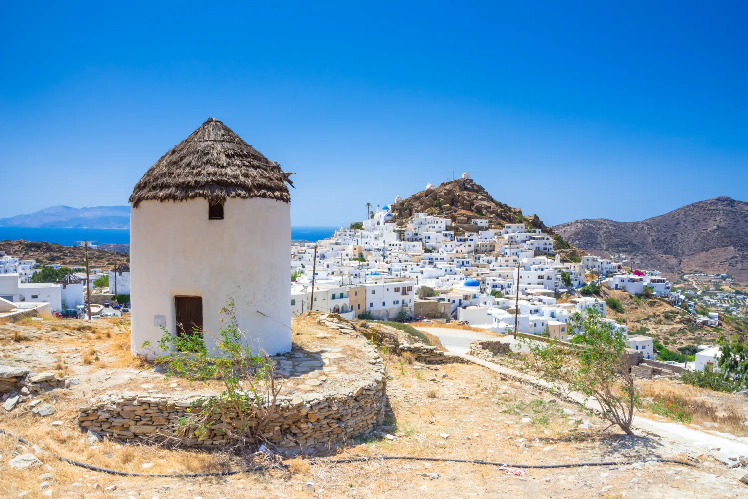 Traditional Wind Mills In Ios and Chora in the background