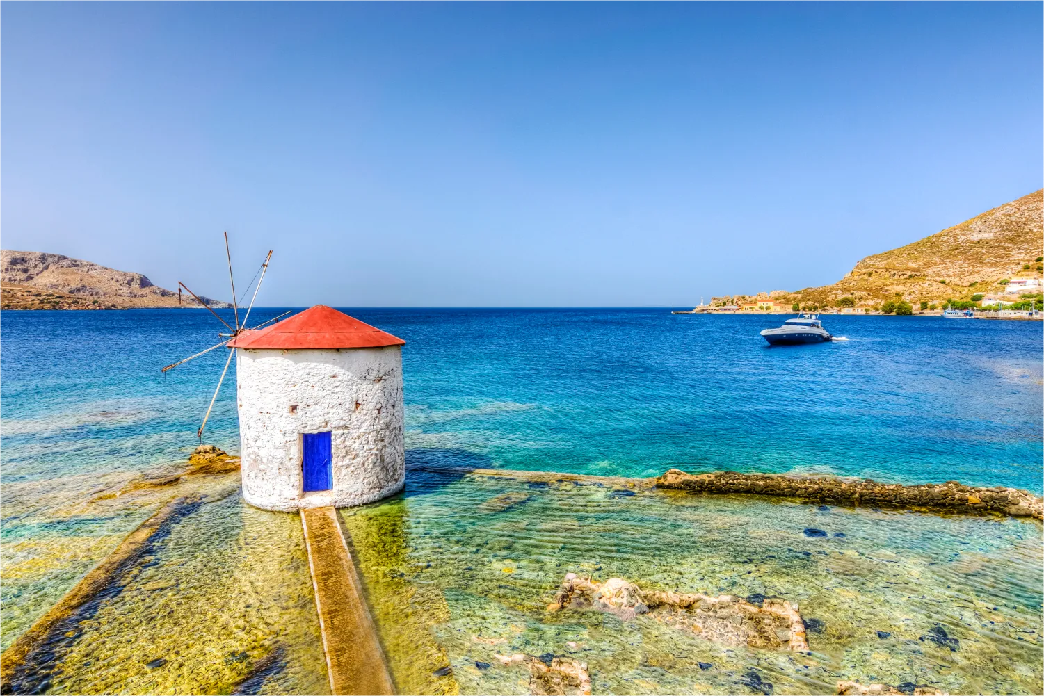 A windmill in the crystal clear sea of Leros