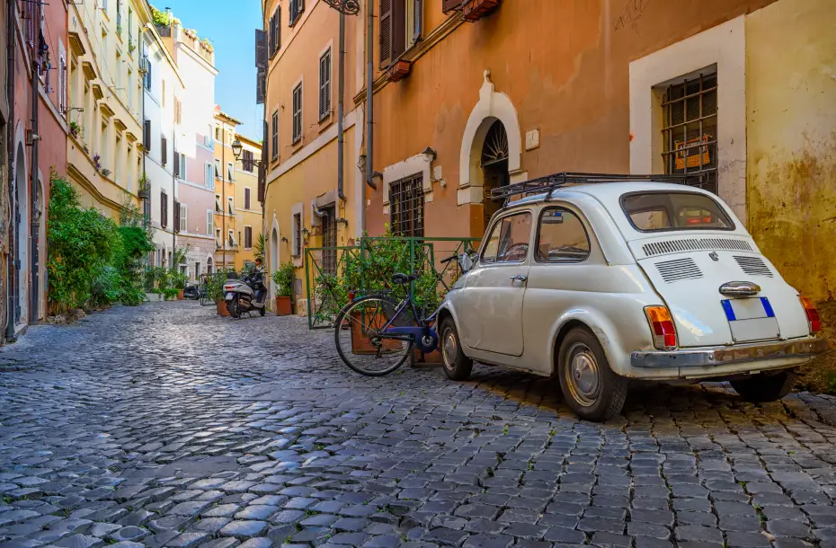 Old street with an italian car parked in Trastevere, Rome, Italy